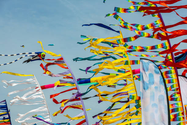 istock Colored flags against the blue sky with white clouds on holidays 1573376442