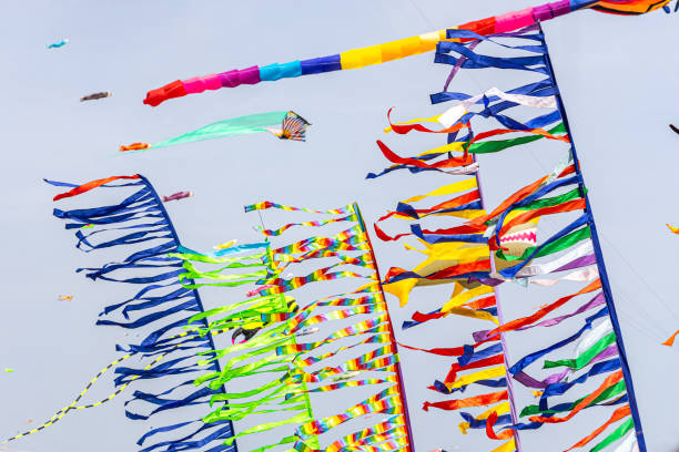 istock Colored flags against the blue sky with white clouds on holidays 1573378995