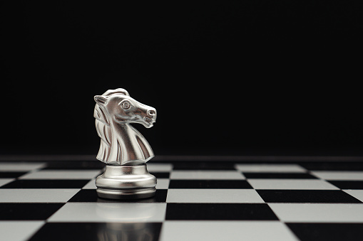 Chess piece on board game planning and competition on black background. Business leadership and strategy concept