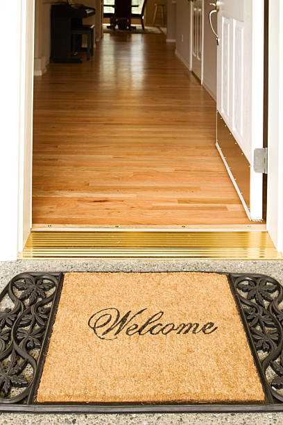 istock A welcome home mat placed outside of an open door 157338615