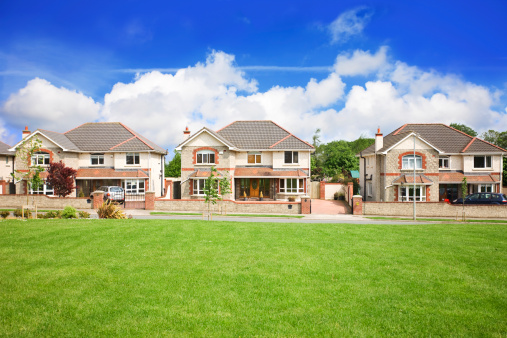 Image of Neighborhood aerial with hundreds of houses on bright sunny day with ponds