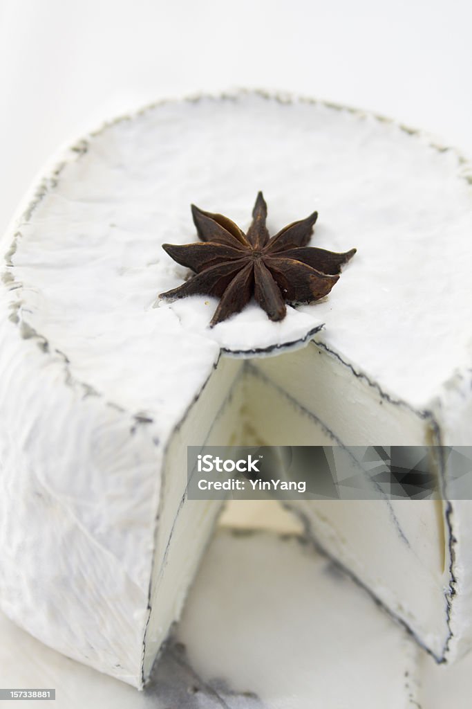 Goat Cheese, Gourmet Cheese with Star Anise Spice Cut Open Subject: A mature goat cheese decorated with a star anise. Aging Process Stock Photo