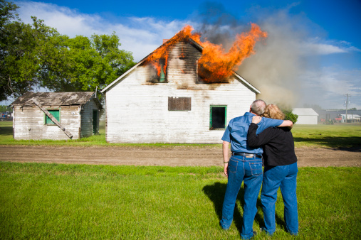 Couple watch as their house is burning to the ground.