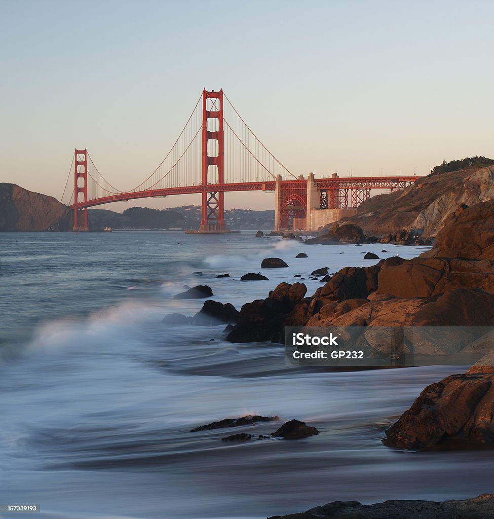 A zoomed out view of the water and the Golden Gate Bridge Golden Gate Bridge Scenic, Pacific Ocean in foreground Red Stock Photo