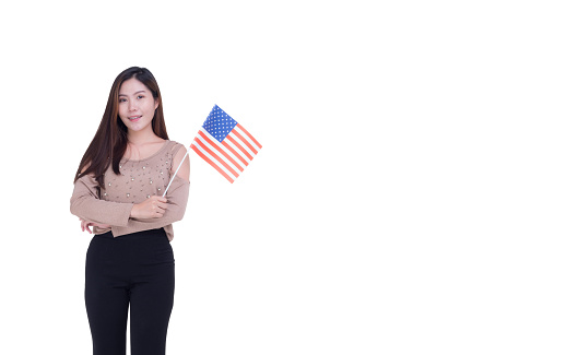 A young woman standing holding the China flag and looking at the camera while standing on a white background.