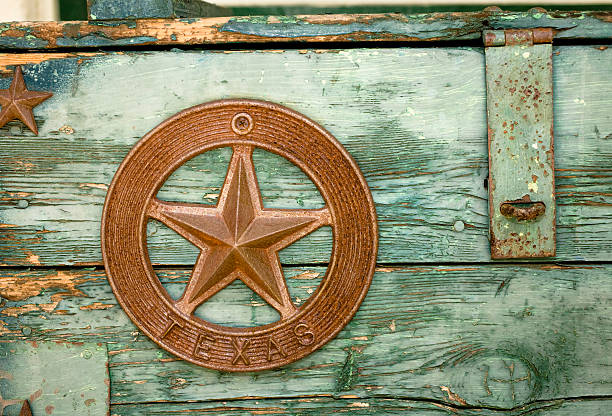 Green paint peeling on Wooden box with Texas star Old green box with peeling paint and hasp.  Texas star emblem on front. houston texas stock pictures, royalty-free photos & images