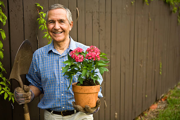 istock Senior with Shovel and Flowers 157339347