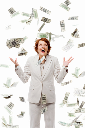 Young business woman standing surprised and ecstatic. Its raining money. A conceptual image of success in business and wealth.