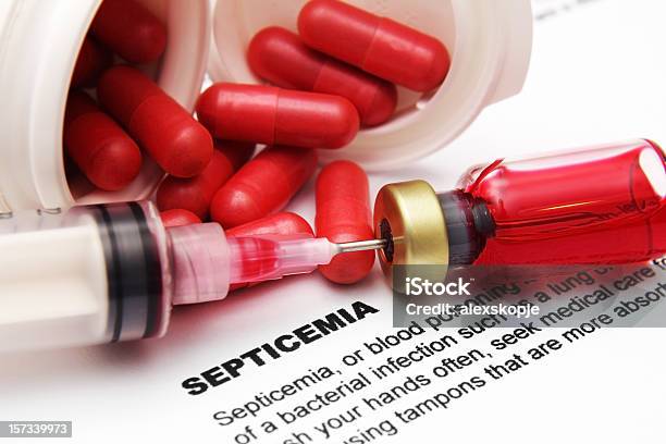 Pills And Needle In Vial On Paper With Info On Septicemia Stock Photo - Download Image Now