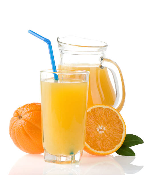 istock orange juice in glass and slices on white 157339980