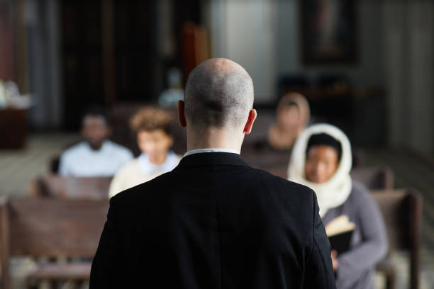istock Pastor talking to believers in church 1573403736