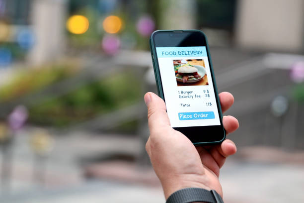 istock Man is ordering  food on  the internet using an app in the downtown. 1573404762
