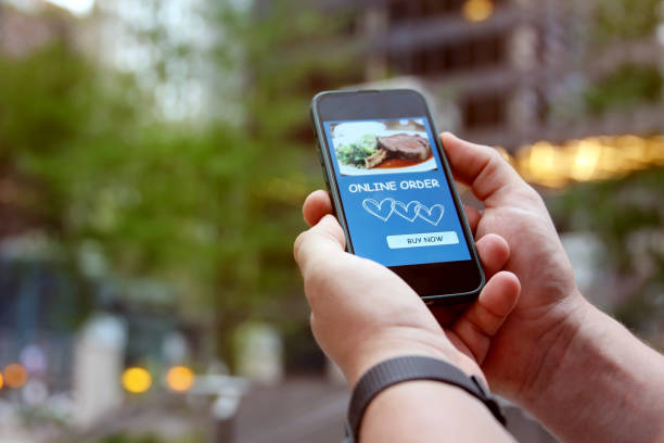 istock Man is ordering  food on  the internet using an app. 1573404768