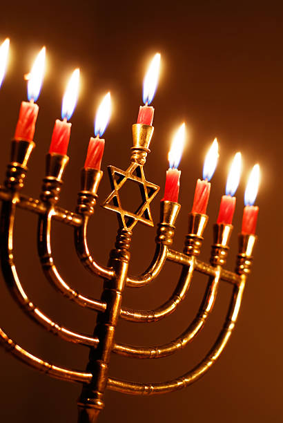 istock Hanukkah Menorah candles in red color 157341119