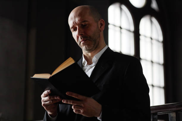 istock Man reading prays in Bible 1573417215
