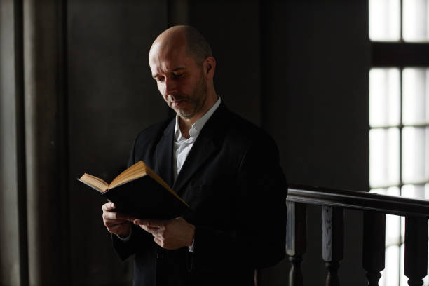 istock Man reading Bible in church 1573417225