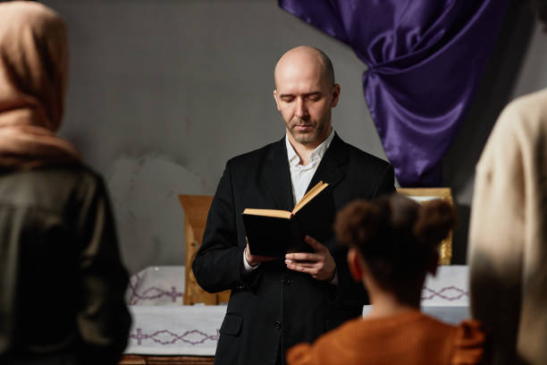istock Pastor reading Bible for believers in church 1573419345