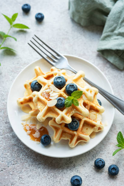 istock Freshly baked waffles with fresh  blueberries 1573432118