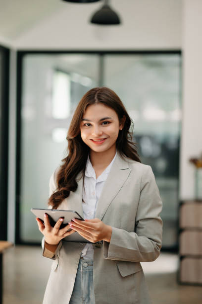 istock Modern business woman in the office with copy space 1573445204