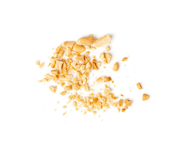 istock Crumbled Peanuts Isolated, Broken Roasted Arachis Nuts, Heap of Pea Nut Crumbs, Whole Groundnut Pieces 1573471929