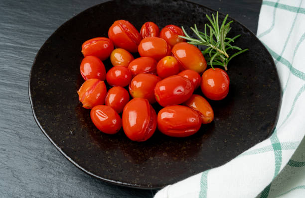 istock Pickled Cherry Tomatoes Isolated, Canned Small Tomato, Healthy Fermented Vegetables, Salted Marinated Food 1573472525