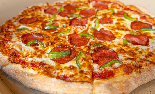 Pepperoni Pizza in Cardboard Delivery Box Closeup, Salami Pizza with Green Paprika, Chili Pepper and Mozzarella Cheese, Traditional Italian Flatbread