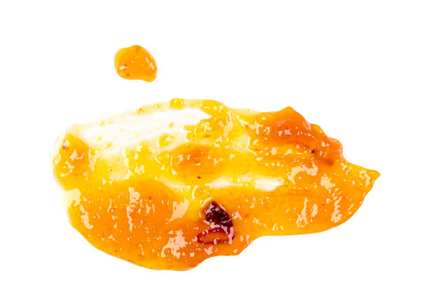 istock Abstract smear of yellow mango sauce, jam isolated on white, top view 1573485610