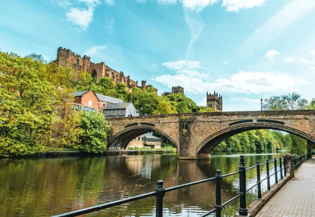 The view of Durham Cathedral, Durham Castle and the Farmwellgate Bridge from the riverbank of River Wear