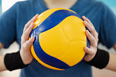 Close up of volleyball ball in hands of female player