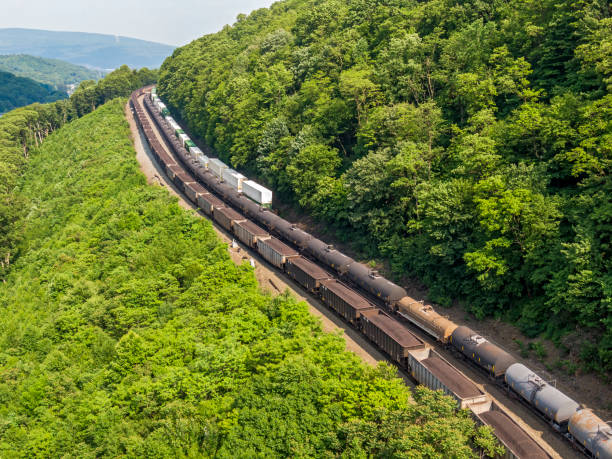 Covington, Virginia, USA - April 2, 2015: A freight train hauling CSX-owned rail cars travels near downtown Covington on a Spring day.