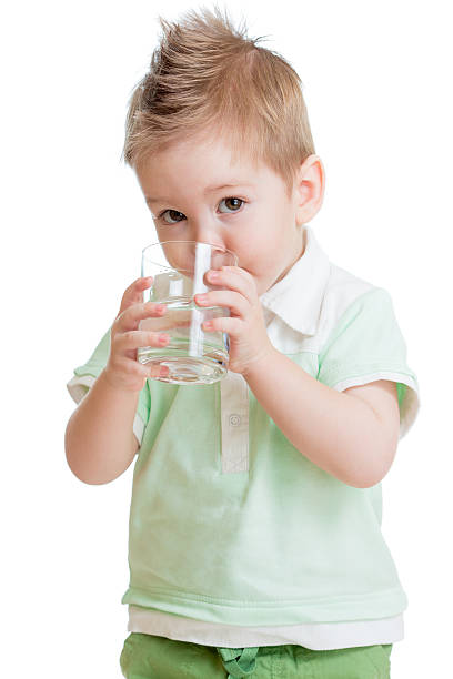 istock Little kid or child drinking water from glass isolated 157353347
