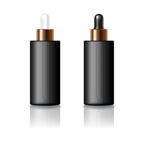 istock Blank black cylinder cosmetic bottle with white and black-copper dropper lid mockup template. 1573540030