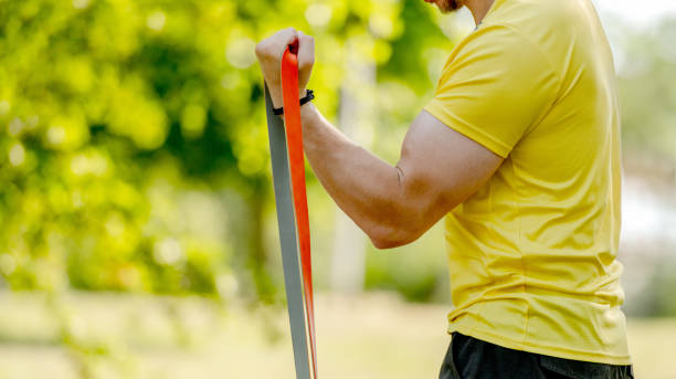 istock Man excercising with elastic rubber band outdoors 1573552959