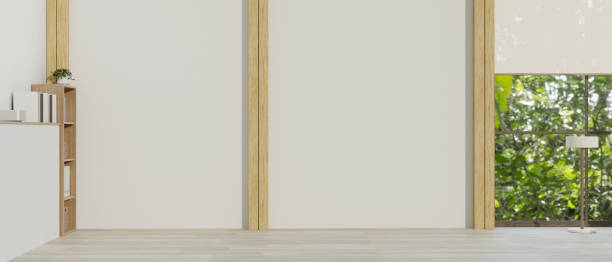 istock An empty room in a minimalist style with empty white wall, modern wood floor, and decors. 1573563634