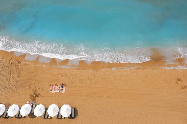 istock Azure sea beach with people top view 1573564595
