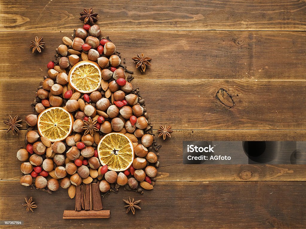 Christmas tree Christmas tree made of nuts, spices and dried oranges. Viewed from above. Almond Stock Photo