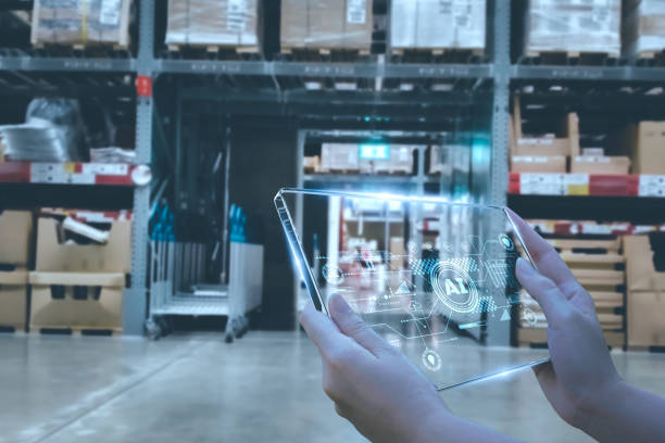 istock Manager using smart tablet monitor process Analyzes, check and control product in stock warehouse, modern software, futuristic concept smart warehouse management system in Factory industry in 1573574801