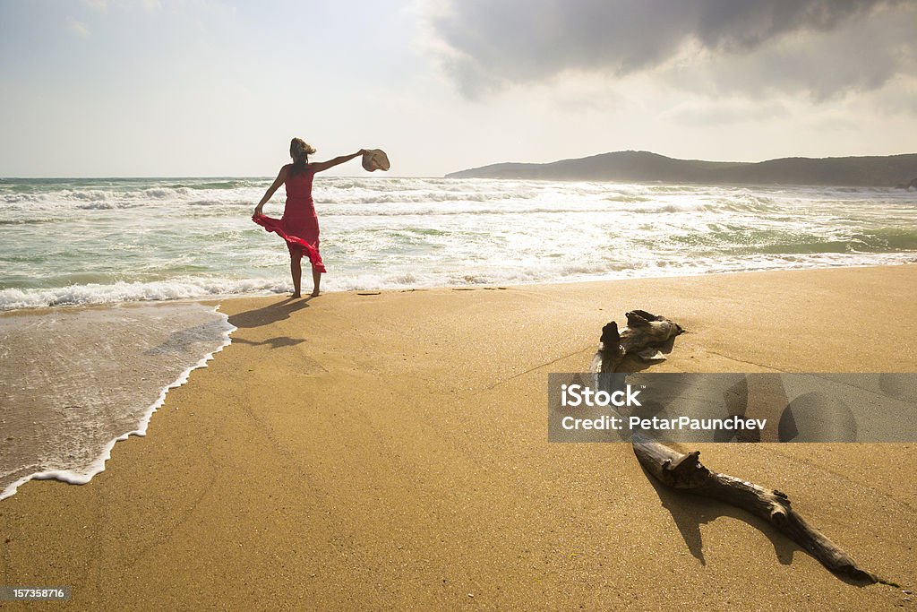 Happy beach freedom Happy young woman enjoys being on a wild beach Adult Stock Photo