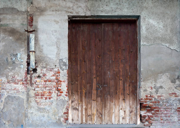 Old rusty brick house window front view.