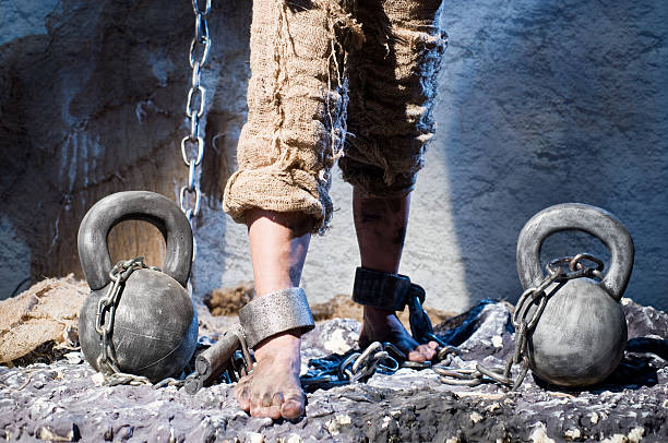 Shackles Legs in heavy iron shackles slavery stock pictures, royalty-free photos & images