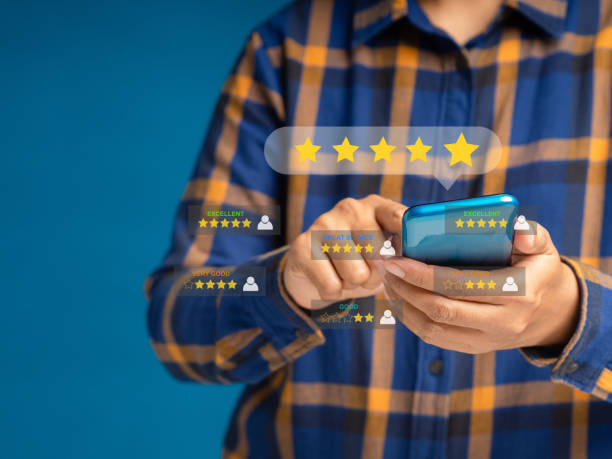 istock Man using a smartphone give the five-star icon a rating of very impressed for service. Customer service and satisfaction surveys concept 1573613678