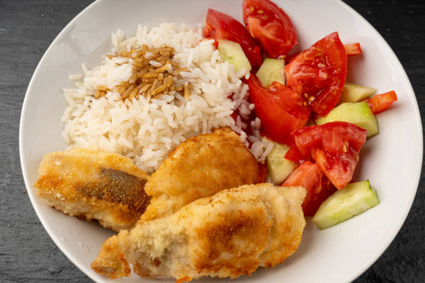 istock Homemade Fried Fish and Rice, Fish in Breadcrumbs 1573622480