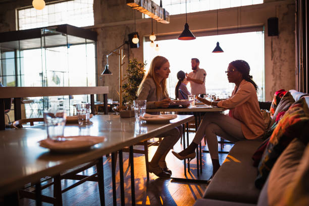 istock Business ladies talking in a restaurant 1573657186