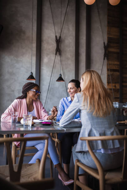 istock Business ladies talking in a restaurant 1573659406
