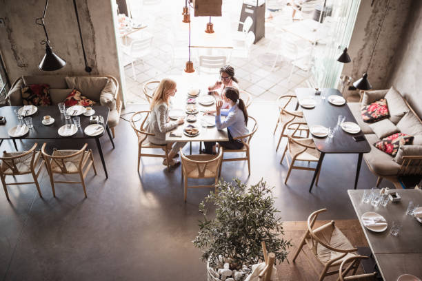 istock Business ladies talking in a restaurant 1573659962