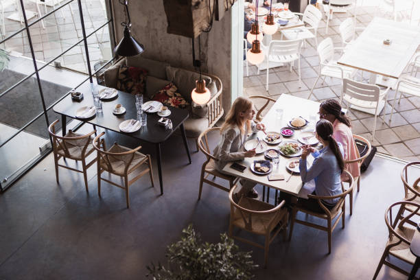 istock Business ladies talking in a restaurant 1573661600