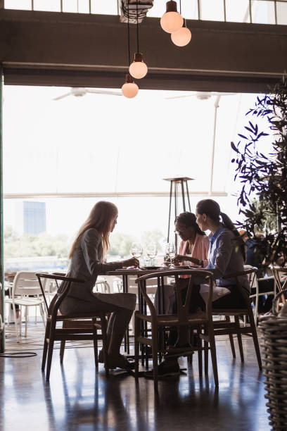 istock Business ladies talking in a restaurant 1573663186