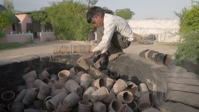 Indian boy working in a pottery workshop, Rajasthan, India