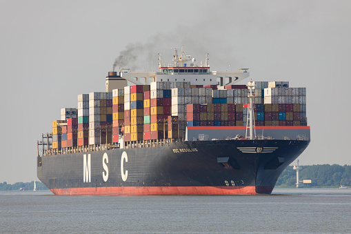 Stade, Germany - June 25, 2021: Container ship MSC REGULUS, built by Hyundai Heavy Industries, currently chartered to Mediterranean Shipping Company (MSC) on Elbe river.