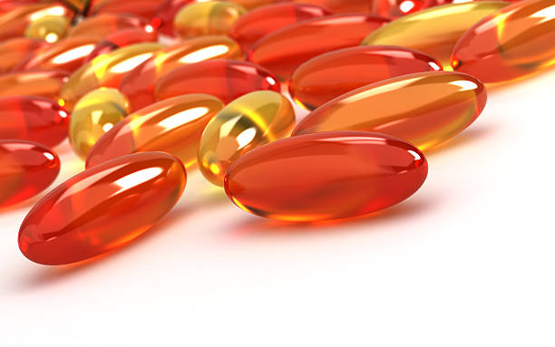 витамины добавки - capsule vitamin pill red lecithin стоковые фото и изображения